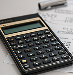 Image of a calculator and a finance document